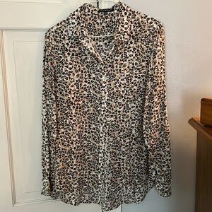 Animal print blouse with button sleeve for rolling.